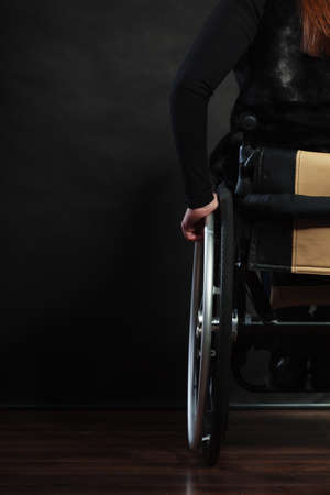 Health invalid disability sad negative tragedy concept. Backside of disabled person. Handicapped lady sitting on wheelchair.の写真素材