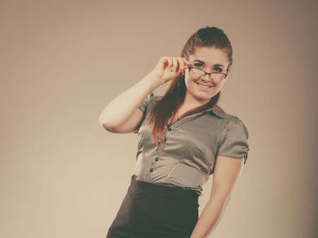 Close up portrait of happy business woman wearing eyeglasses and grey shirt.の写真素材