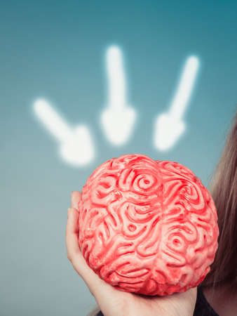 Woman hand holding brain. Having something on mind, thinking of solution idea concept.の写真素材