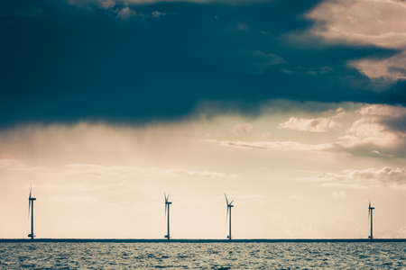 Wind turbines generator farm for renewable sustainable and alternative energy production along coast...