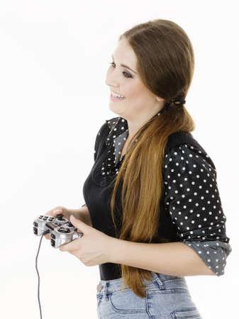 Young adult woman playing on the video console holding game pad. Gaming gamers concept.