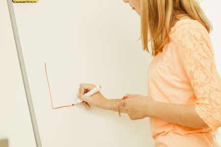 Education, knowledge, wisdom and learn new things concept - student girl writing Learning word on whiteboard inviting to joinの写真素材