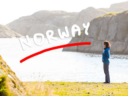 Tourism vacation and travel. Woman tourist enjoying ocean view from rocky coast, Norway Scandinavia.の写真素材