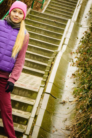 Outdoor sport exercises, sporty outfit ideas. Woman wearing warm sportswear training exercising outside during autumn, warming up before workout.の写真素材