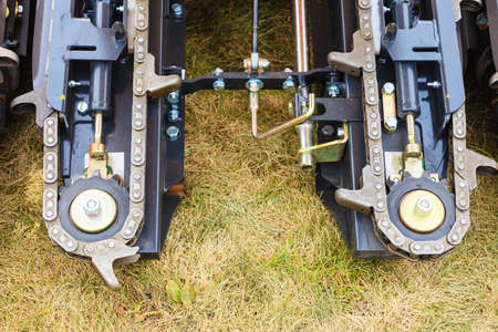 Agricultural harvesting industrial equipment concept. Agriculture machinery. Closeup of cutting chainsの写真素材