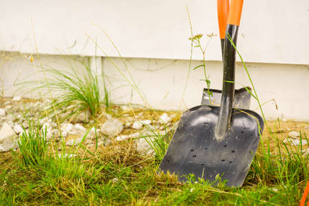 Shovel spade work tools standing outside. Gardening and agricultural equipment essentials concept.の写真素材