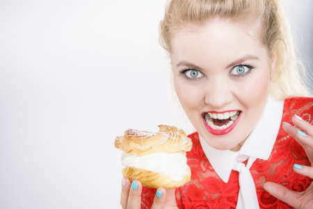 Woman holding sweet cupcake cake dessert with cream, she wants to eat it.の写真素材