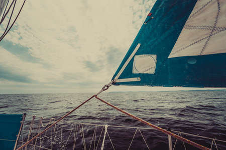 Detailed closeup of sail fabric on sailboat, outdoor shot. Marine objects concept.の写真素材