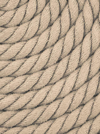 Old nautical objects concept. Circle rounded antique chest rope coil on wooden floor.の写真素材