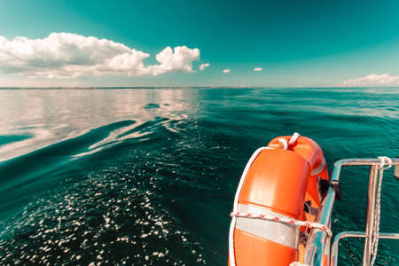 Detailed close up of rescue ring on sailing boat handrail during cruise on waterの写真素材