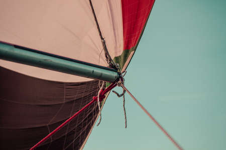 Spinnaker with uphaul on sail boat, blue sky in background. Marine sailing objects concept.の写真素材
