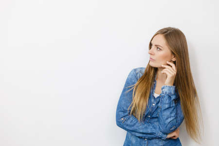 Fashion, clothing, people concept. Attractive young woman with jeans jacket. Girl is posing in the studio.の写真素材