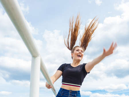 Happy joyful smiling woman spending her free time outside enjoying beautiful summertime weather.の写真素材