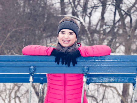 Woman wearing warm sportswear getting ready before exercising, running jogging outside during winter.の写真素材