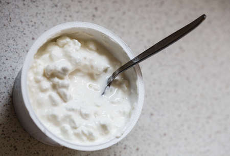 Healthy food, desserts dishes during diet, dairy products concept. Detailed closeup of white yoghurt with rise or cheese.の写真素材