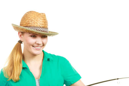 Fishery, spinning equipment, angling sport and activity concept. Happy woman with fishing rod.の写真素材