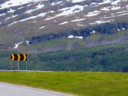 Road running through norwegian mountains. Beautiful landscape. Travel and tourism.の写真素材