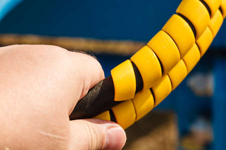 Machines, production concept. Electrical tube wires in orange rubber protective cover casing