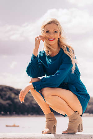 Fashionable woman wearing blue jumpsuit shorts perfect for summer. Fashion model outdoor photo shoot