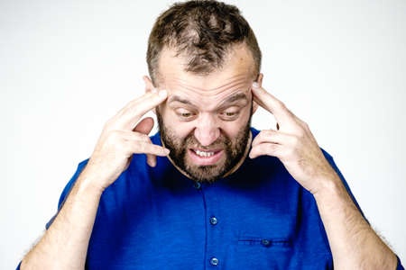 Adult man being worried about something. Guy gesturing with hands seeing unpleasand bad effects.の写真素材