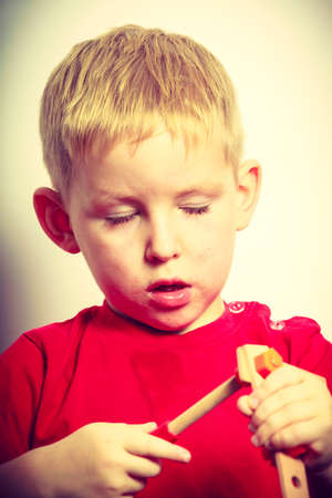 Childhood, kids imagination concept. Concentrated little boy playing with toys having funの写真素材