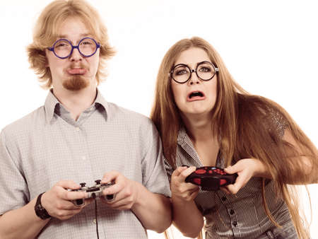 Happy couple enjoying leisure time by playing video games together. Studio shot isolated