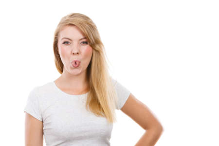 Fooling around, making silly faces concept. Blonde woman having tongue in clothespin