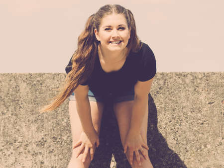 Happy teen pretty woman enjoying her leisure time. Female having fun outdoor.