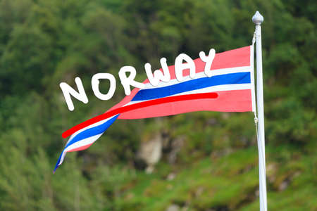 The norwegian flag on green grassy backgroundの写真素材