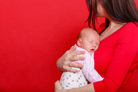 Family parenting, beauty of motherhood concept. Mother holding her little newborn babyの写真素材