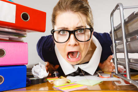 Mobbing at work, bad job relations concept. Depressed businesswoman being sad and tired sitting...