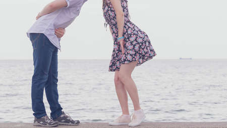 Unrecognizable man and woman about to kiss. Female wearing floral dress. Cute couple outdoor date.の写真素材
