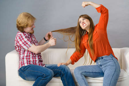 Teen brother and sister having horrible fight, man pulling woman hair. Friendship and family...