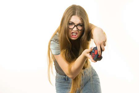 Young emotional adult woman playing on the video console holding pad being very into game. Gaming...