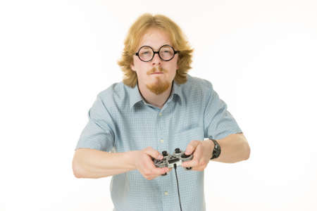 Nerd geek young adult man playing on the video console holding game pad. Gaming gamers concept.