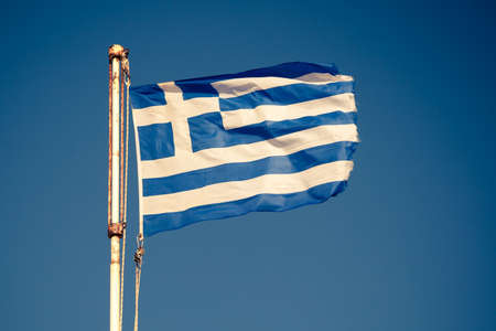 Close up of blue nad white Greek flag waving on wind. National landmark concept.の写真素材