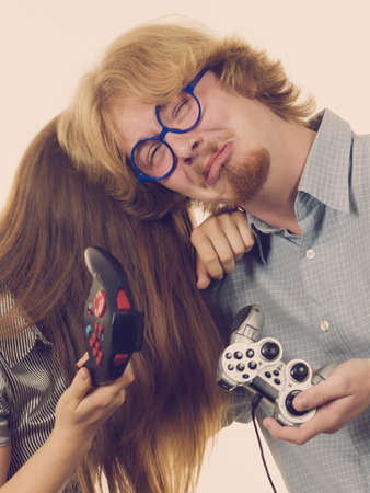 Couple being sad after they lost video game holding joystick pads. Relationship spending time together.の写真素材