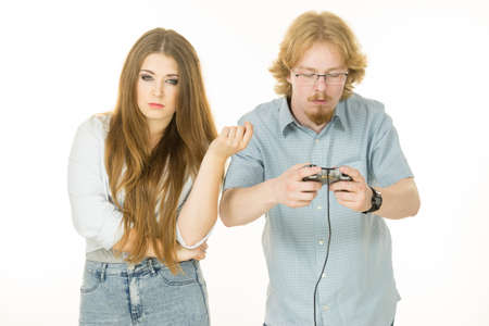 Woman is mad at her boyfriend because he play video games being addicted to gaming.の写真素材