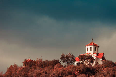 Little church chapel on hill, blue sky with stormy clouds, Republic of Macedonia