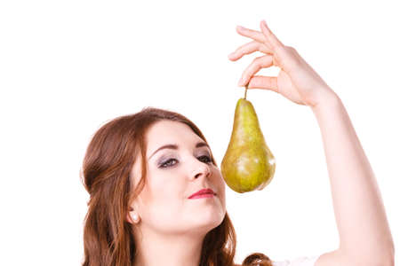 Woman dark hair holding green pear fruit, recommend detox fruit diet, isolated on white. Healthy dieting, vegan food, vitamins immunity concept.の写真素材