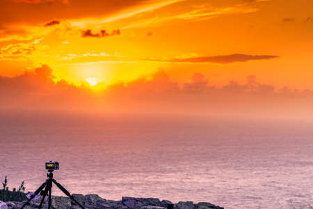 Professional camera taking picture film video of sunset over sea surface, Greece Peloponnese Mani Peninsula.の写真素材