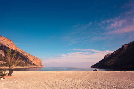 Beautiful Greek sandy beach near mountains. Beauty of nature concept.