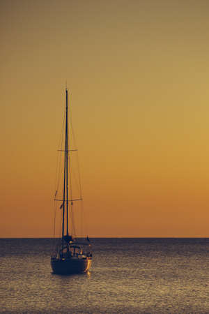 Yacht on sea water at scenic sunrise or sunset.. Travel cruise holidays concept.の写真素材