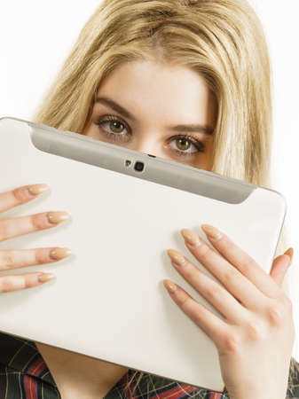 Young teenage woman using tablet surfing on internet, working or getting inspirations.