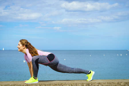 Super fit attractive young woman wearing fashionable outfit working out being active outside during...