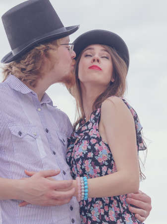 Vintage retro couple, man and woman enjoying their romantic date outside wearing fedora hats.の写真素材