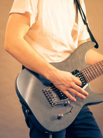 Unrecognizable teenage man playing on electric guitar indie rock. Musical instruments concept.の写真素材