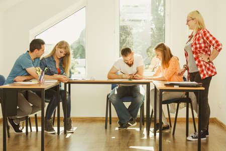 Group of young people sitting in class planning concept, studying together creating new startup enjoying their work time.の写真素材
