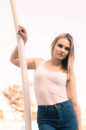 Beauty of female. Young cute beautiful woman posing outside. Attractive girl wearing white t-shirt.