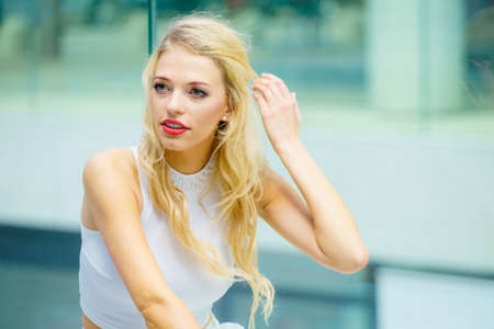 Glamurous female fashion model presenting casual elegant outfit. Woman wearing crop top. Summer...